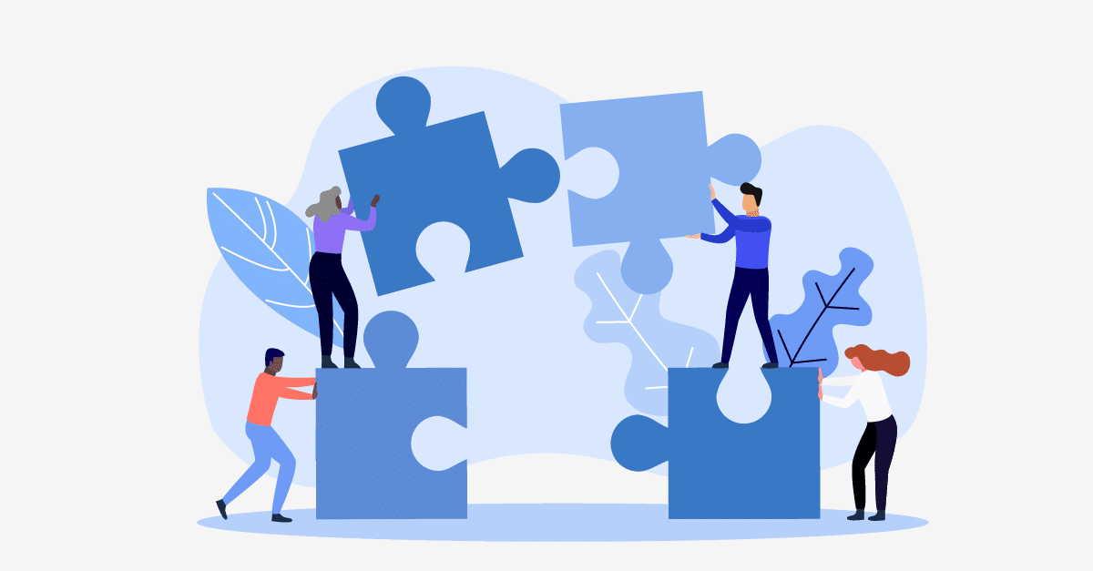 four people putting together giant puzzle pieces