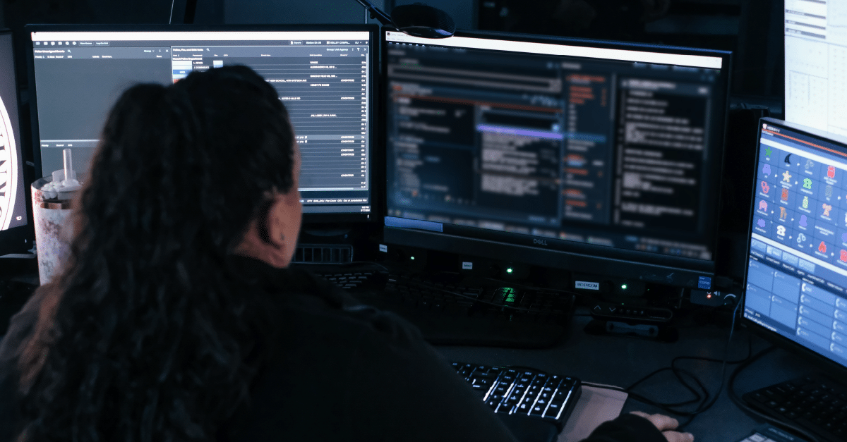 medical dispatcher working on 3 computer screens