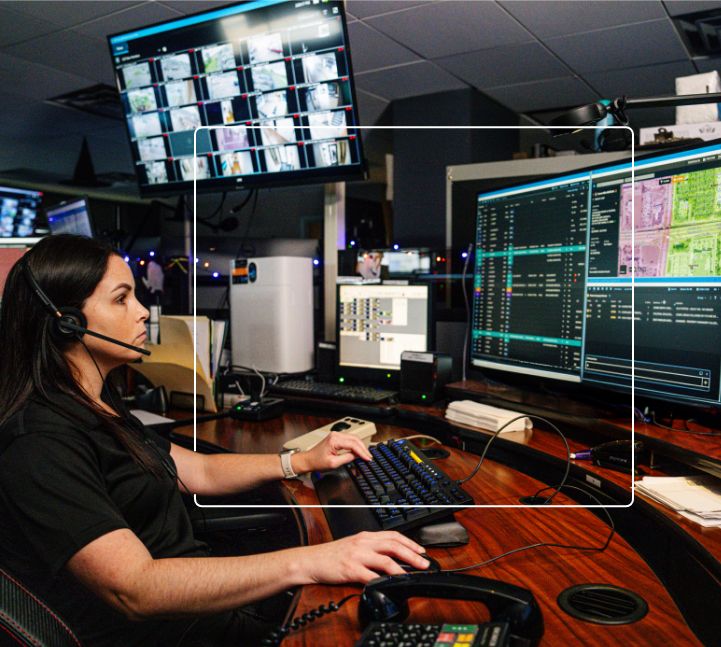 Medical dispatcher wearing a headset and working on the computer