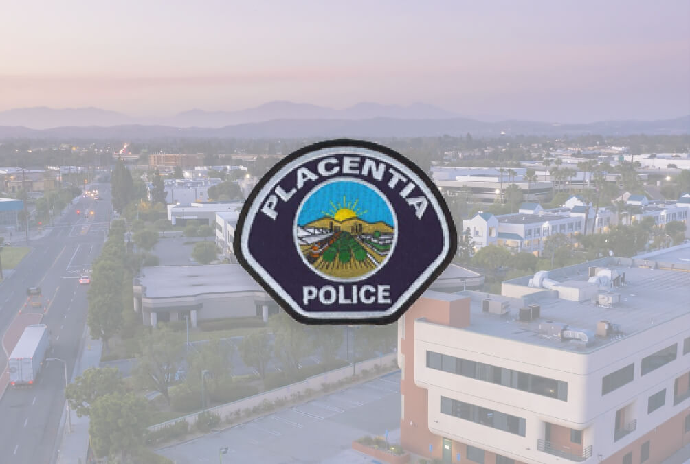 Placentia police badge and the cityscape behind it