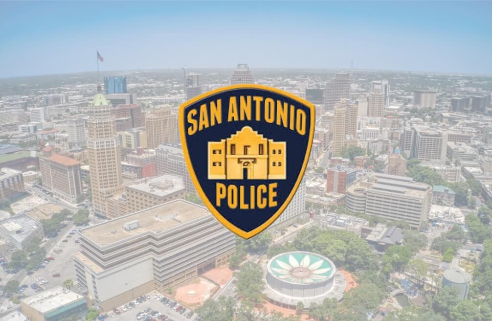 San Antonio police badge and the cityscape behind it